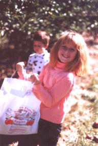 Rachael holding the bag while gathering apples..aw
